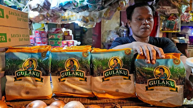 Sprzedawca organizuje paczki cukru na targu w Dżakarcie w Indonezji, 24 października 2023 r.