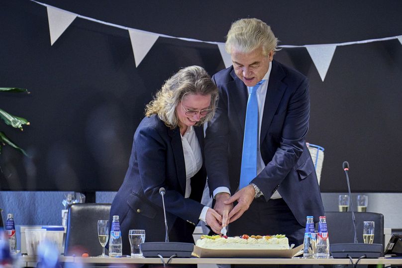 Lider skrajnie prawicowej Partii Wolności Geert Wilders (z prawej) kroi tort z Fleur Agemą w Hadze, 23 listopada 2023 r.