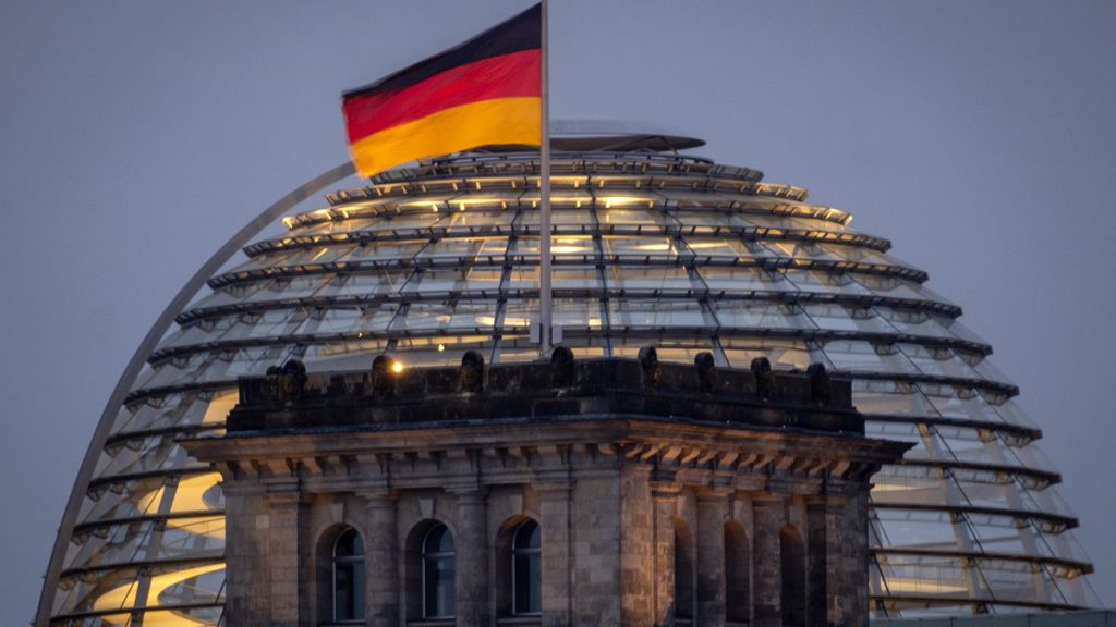 German national flag waves on top of the Reichtstag building in Berlin