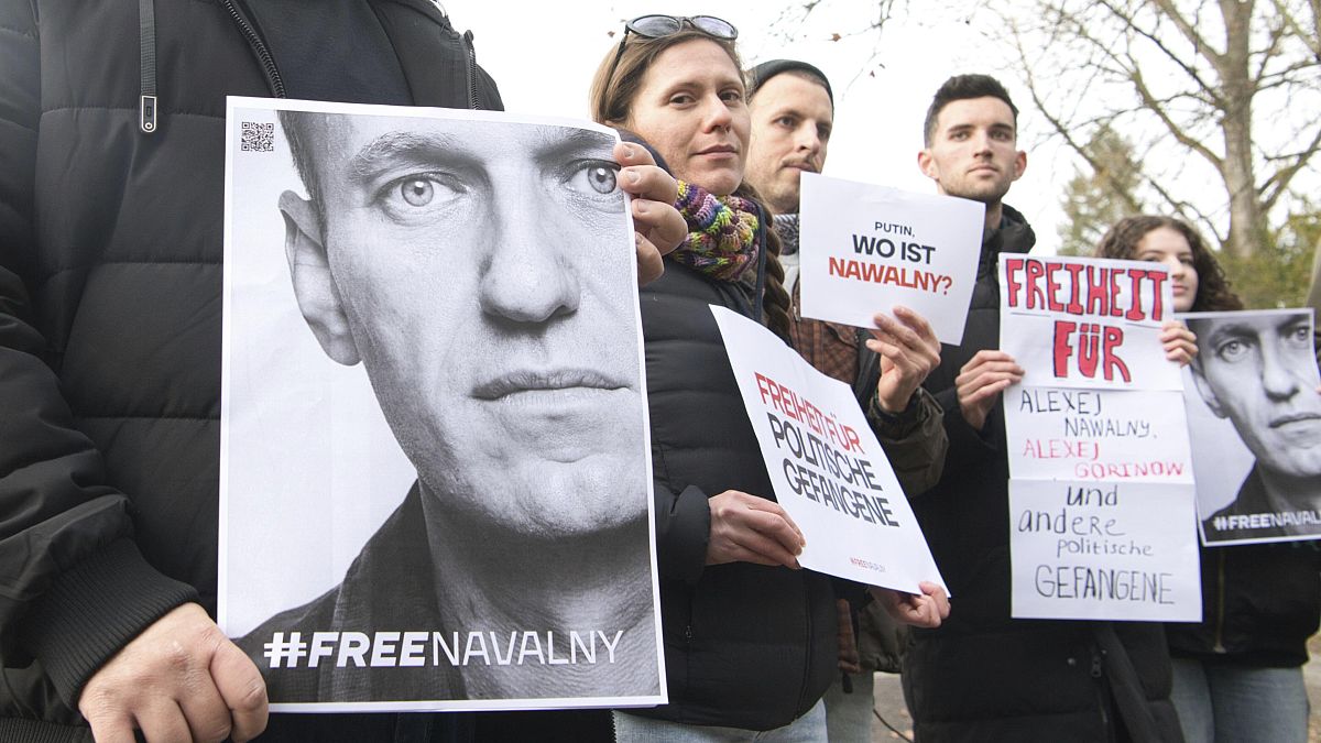 Demonstrators gather outside the home of Russian ambassador Sergei Netshaev in Berlin, Saturday Dec. 16, 2023.