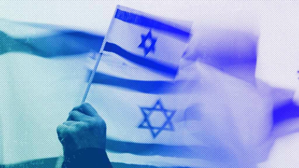 A demonstrator waves the flag of Israel during a rally in Bellevue, WA, October 2023