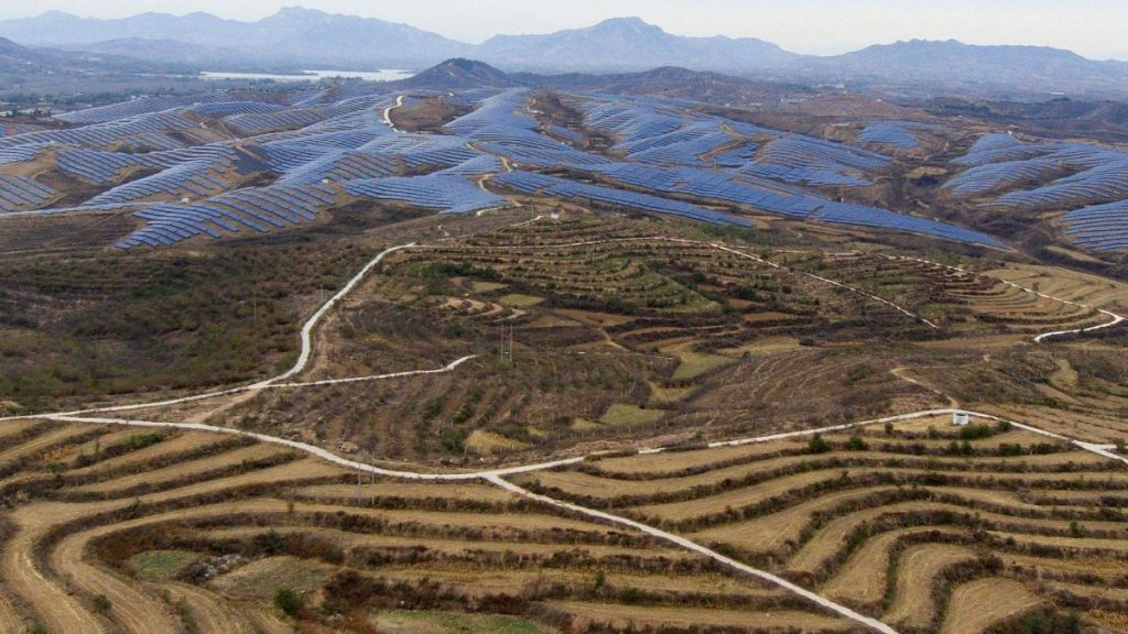 A solar farm operates next to Donggou village in the northern China