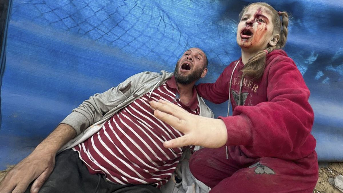 Wounded Palestinians react after an Israeli strike on Al Zawayda, central Gaza Strip, Thursday, Dec. 28, 2023.