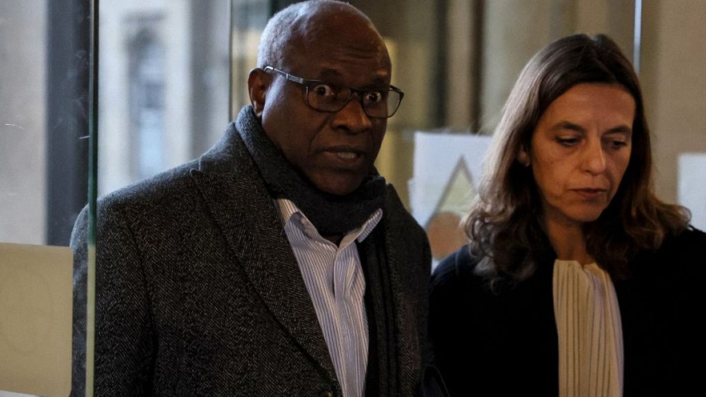 Sosthene Munyemana, a Rwandan doctor, arrives at the Palais de Justice with his lawyer Florence Bourg