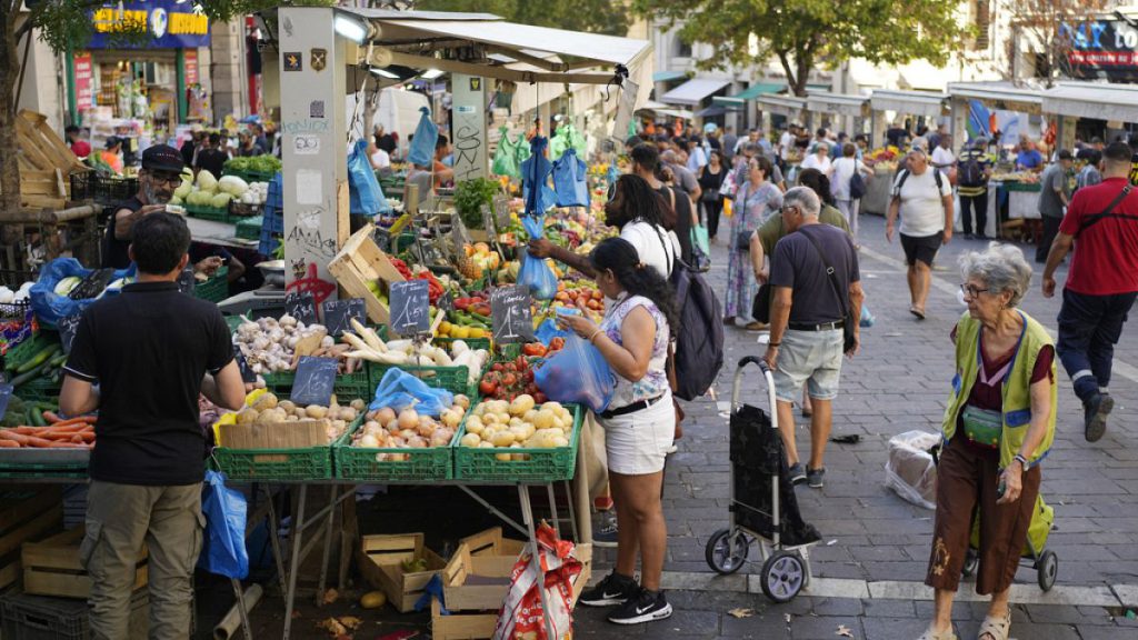 People shop at a street grocery market in Marseille, France, Thursday, Sept. 14, 2023.