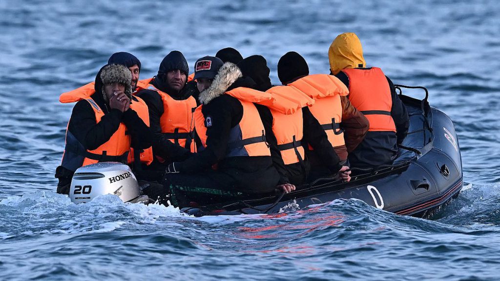 Migrants travel in an inflatable boat across the English Channel, bound for Dover on the south coast of England.