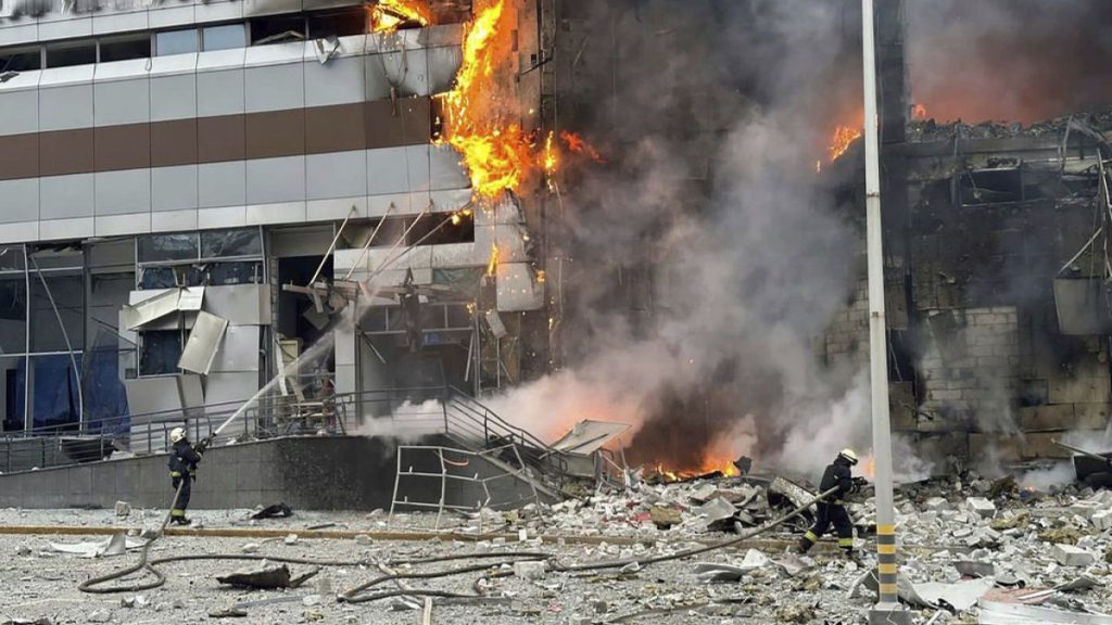 firefighters work on a site of a building damaged after a Russian attack in Kyiv, Ukraine, Friday, Dec. 29, 2023.