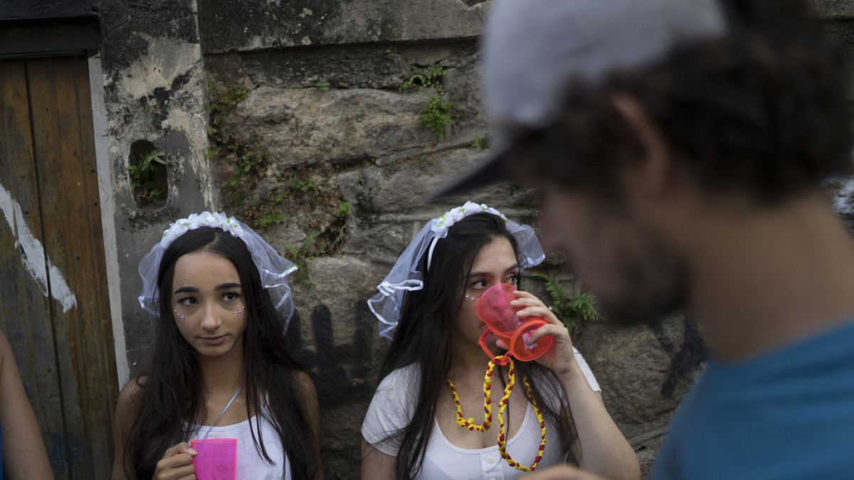 Revelers wearing bride costumes attend the Carmelitas street party in Rio de Janeiro, Brazil, Friday, Feb. 24, 2017.