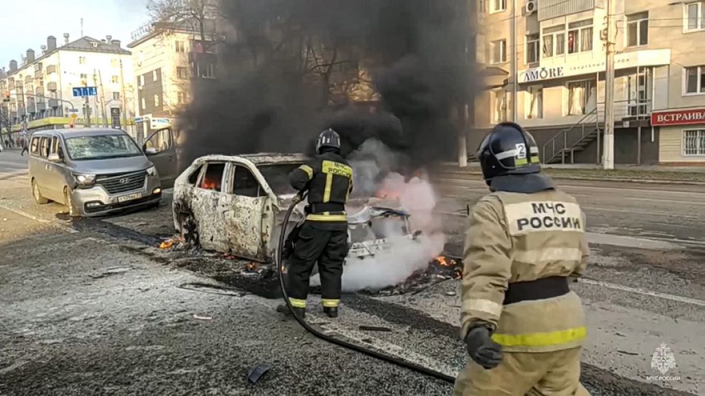 Firefighters extinguish burning cars after shelling in Belgorod, Russia