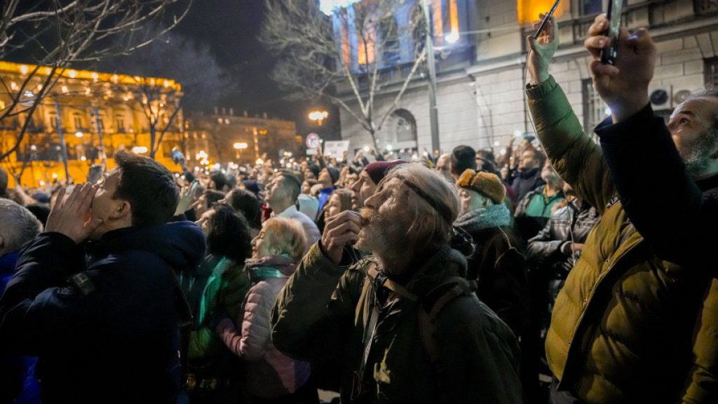 Serbian opposition supporters protest outside the country