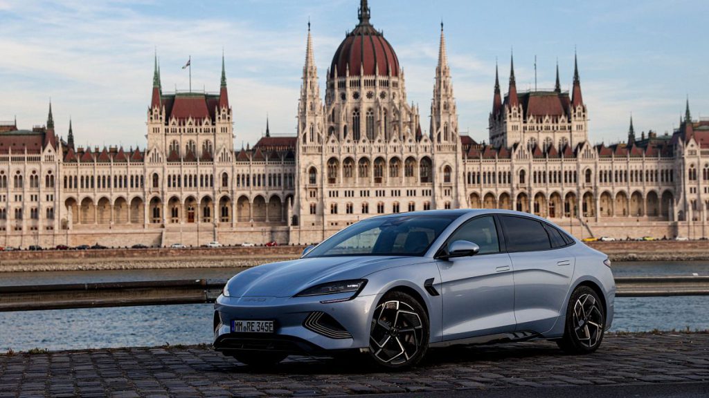 A BYD SEAL model photographed with the Hungarian parliament in the background.