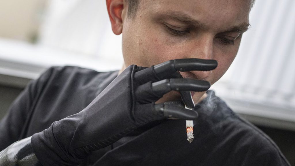 Man fitted with bionic arm smokes