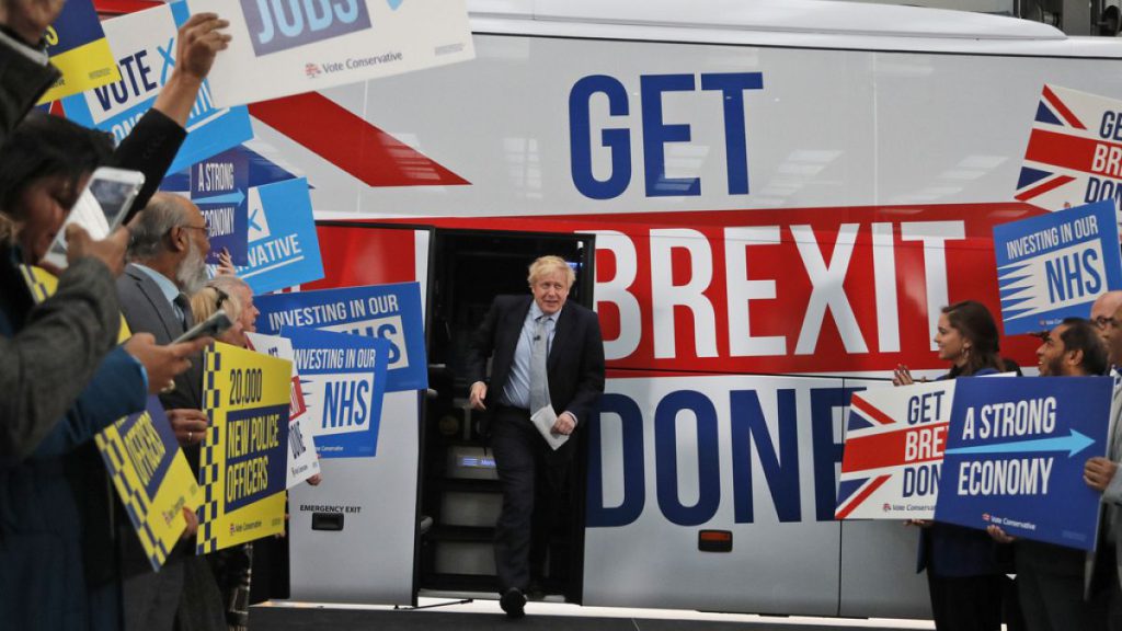 Then-Prime Minister Boris Johnson addresses his supporters prior to boarding his General Election campaign trail bus in Manchester, England in 2019