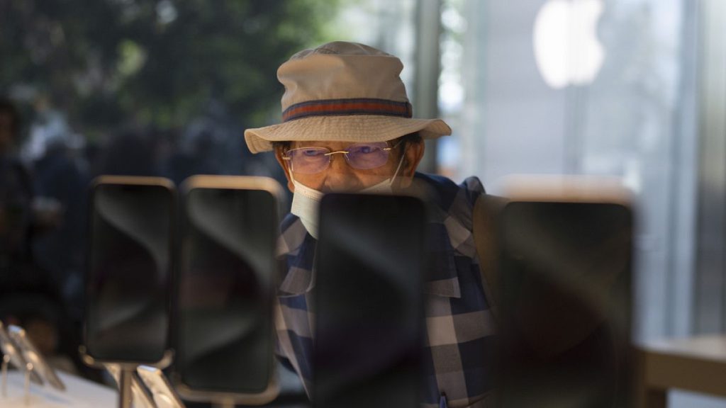 A man looks at the Apple