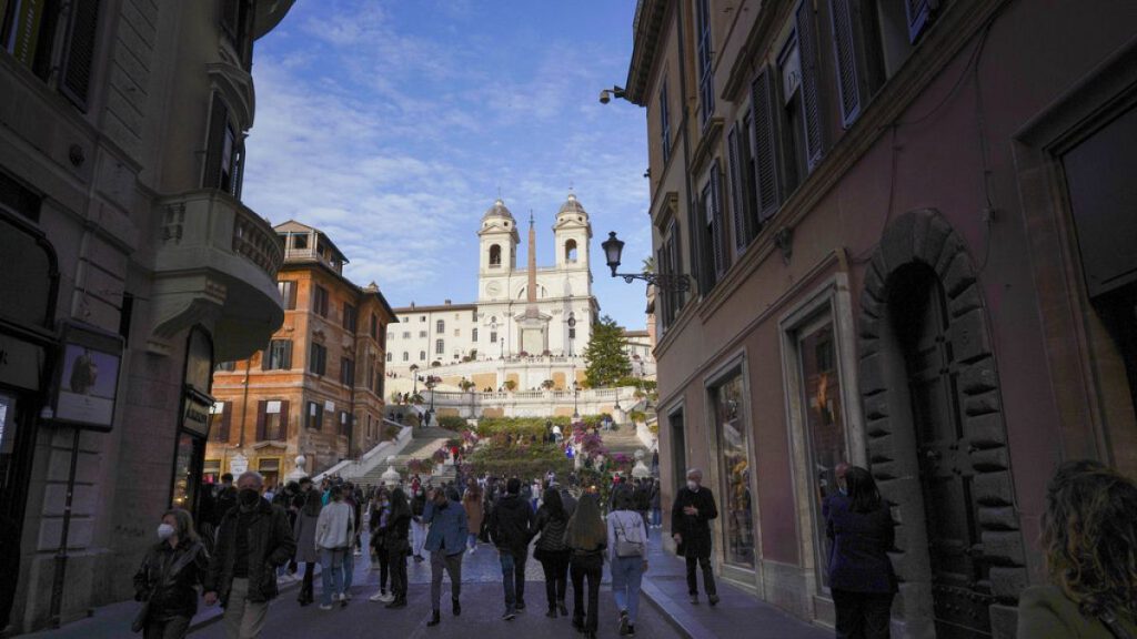 People walk on the Spanish Steps decorated with flowers, in downtown Rome, Saturday, April 17, 2021.