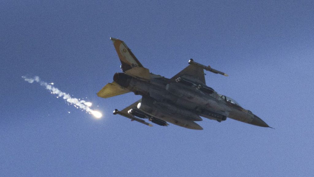 FILE - An Israeli fighter jet releases flares as it flies over the Gaza Strip, as seen from southern Israel, Saturday, Dec. 9, 2023.