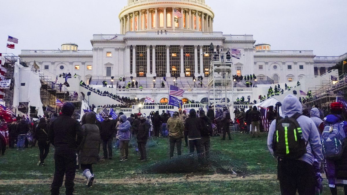 Rioters walk on the West Front at the U.S. Capitol on 6 January, 2021, in Washington DC