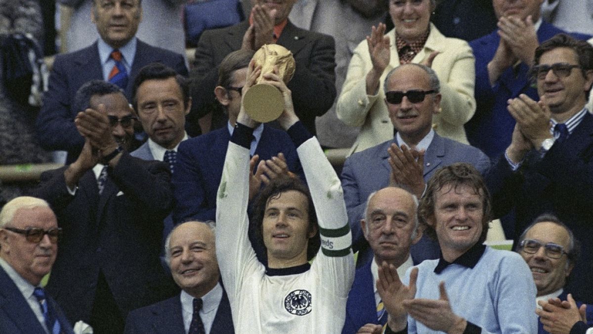 West Germany captain Franz Beckenbauer holds up the World Cup trophy after his team defeated the Netherlands by 2-1, in the World Cup soccer final at Munich