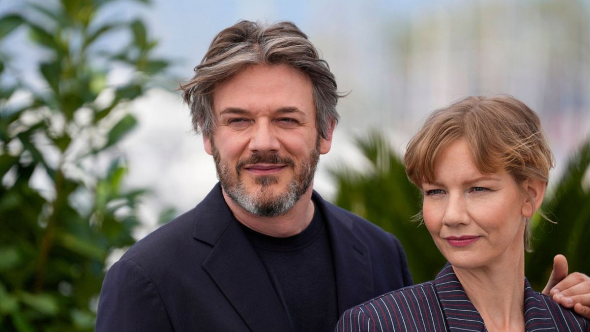 Samuel Theis, left, and Sandra Huller pose for photographers at the photo call for the film