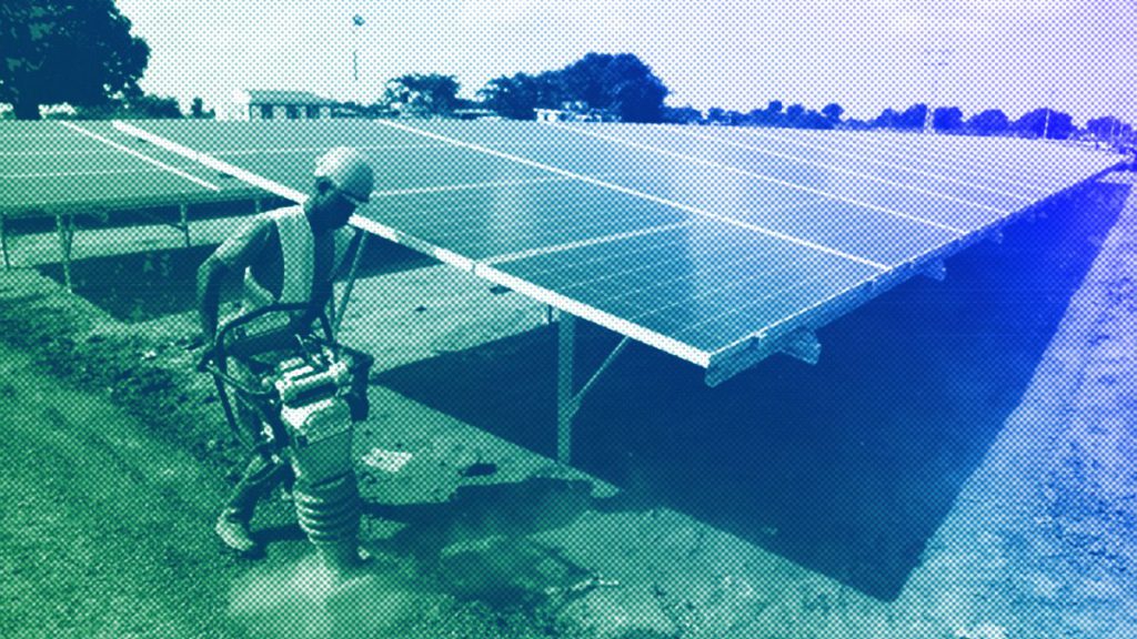 Worker levels the ground at a solar plant in Soroti about 300 kilometers east of Uganda capital Kampala, June 2016