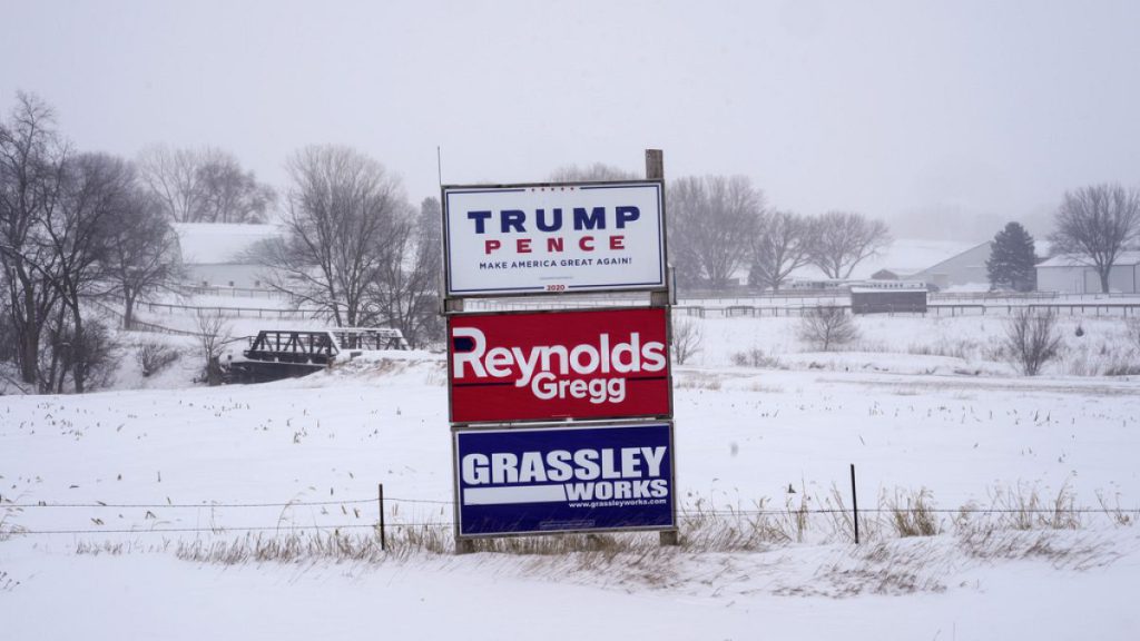 Campaign signs are seen during a winter storm in Sioux City, Iowa