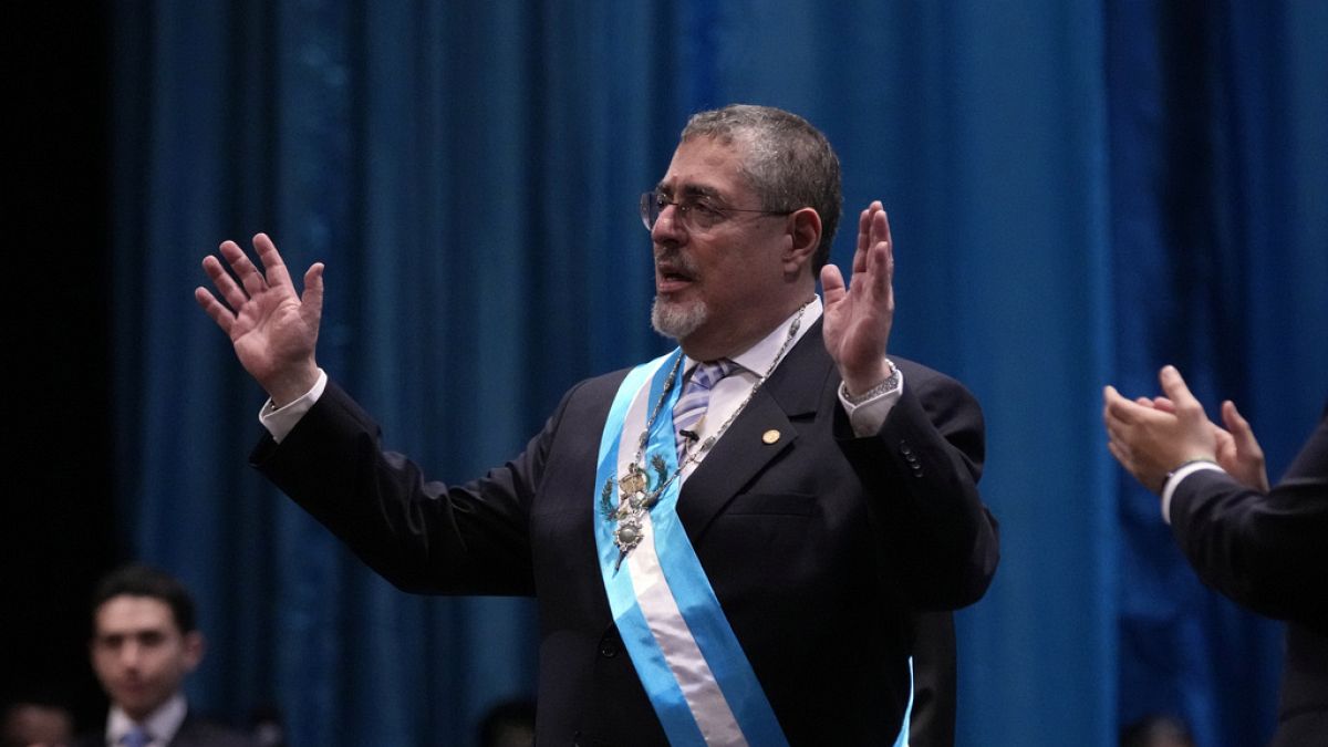 Incoming Guatemalan President Bernardo Arévalo acknowledges the crowd after receiving the presidential sash during his swearing-in ceremony in Guatemala City.