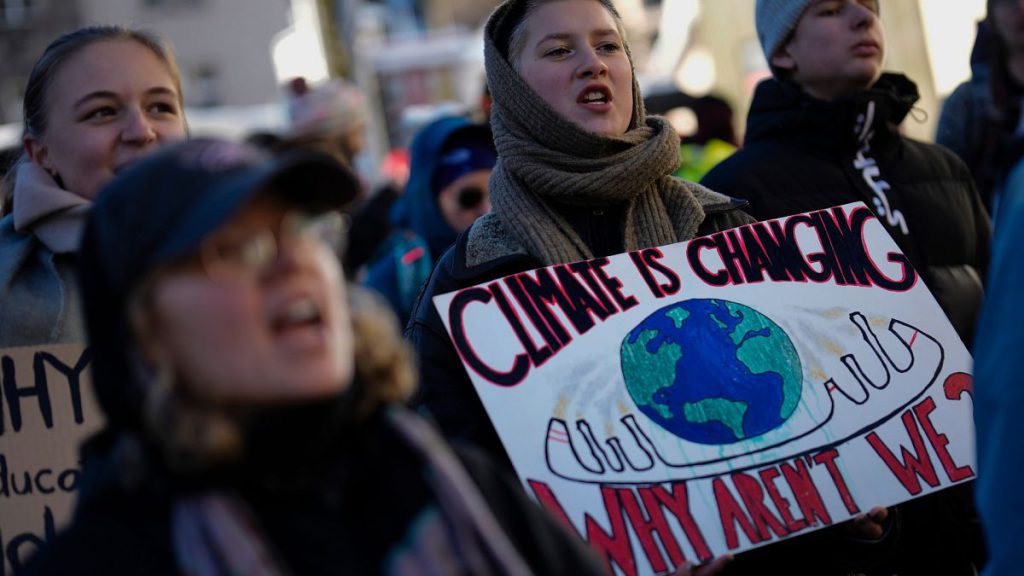 Demonstrators shout slogans during a demonstration against the World Economic Forum in Davos, Switzerland, Sunday, Jan. 14, 2024.