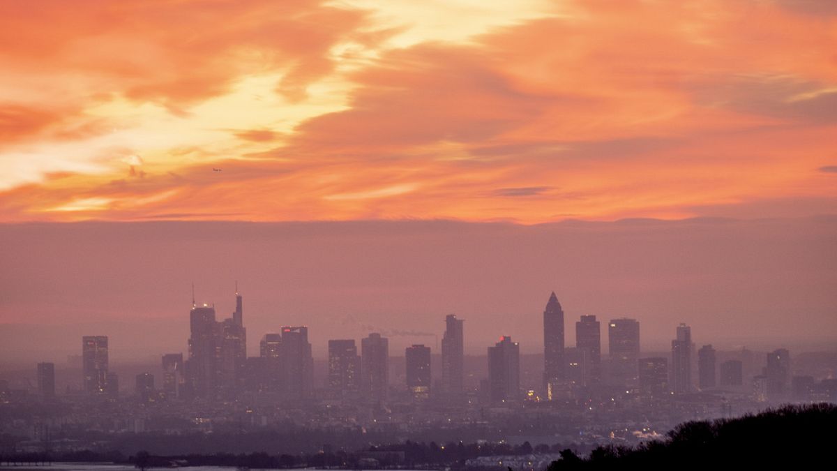 The sky reddens as the sun rises over the buildings of the banking district in Frankfurt, Germany, on Tuesday Jan. 16, 2024