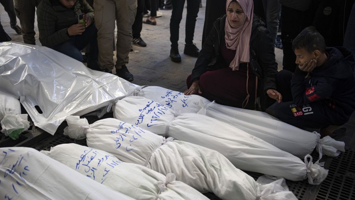 Palestinians mourn their relatives killed in the Israeli bombardment of the Gaza Strip, outside a morgue in Rafah, southern Gaza