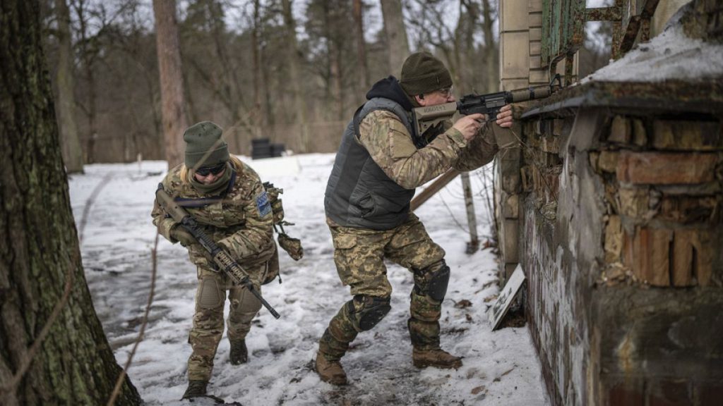 People practice combat skills in urban areas during a training course for national resistance of the Municipal Guard near Kyiv, Ukraine