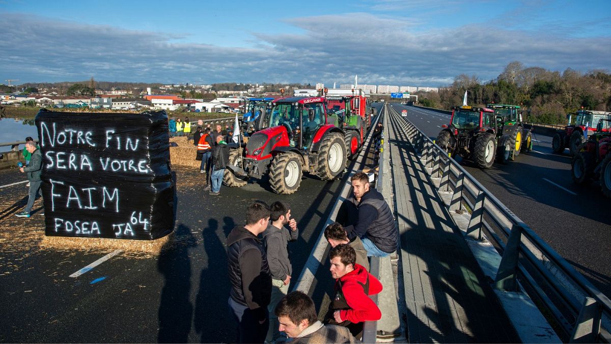 French farmers block the Hubert Touya viaduct on a highway Tuesday, Jan. 23, 2024 in Bayonne, southwestern France.