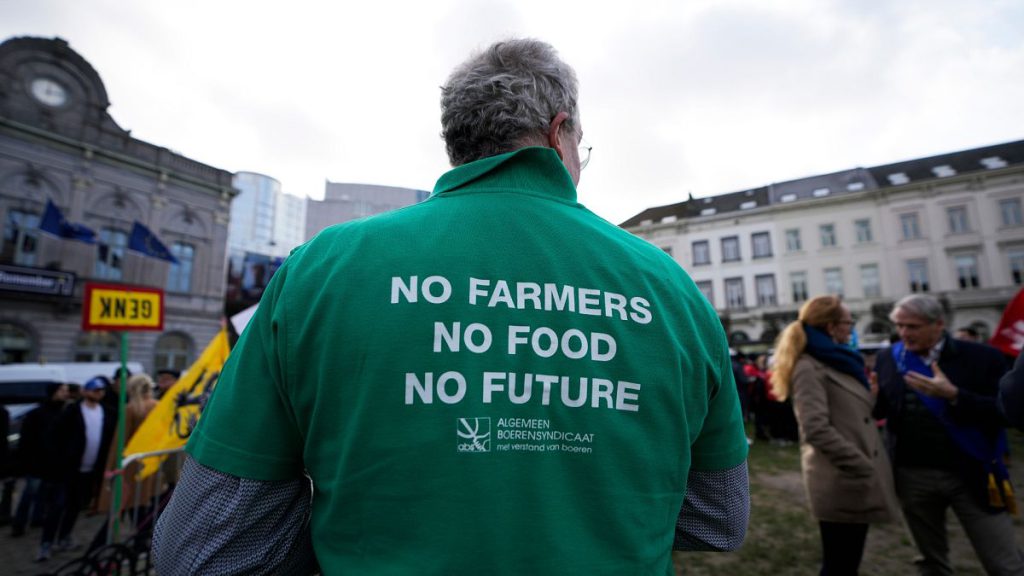 A farmer wears a shirt with a message during a demonstration of French and Belgian farmers outside the European Parliament in Brussels, Wednesday, 24 Jan, 202