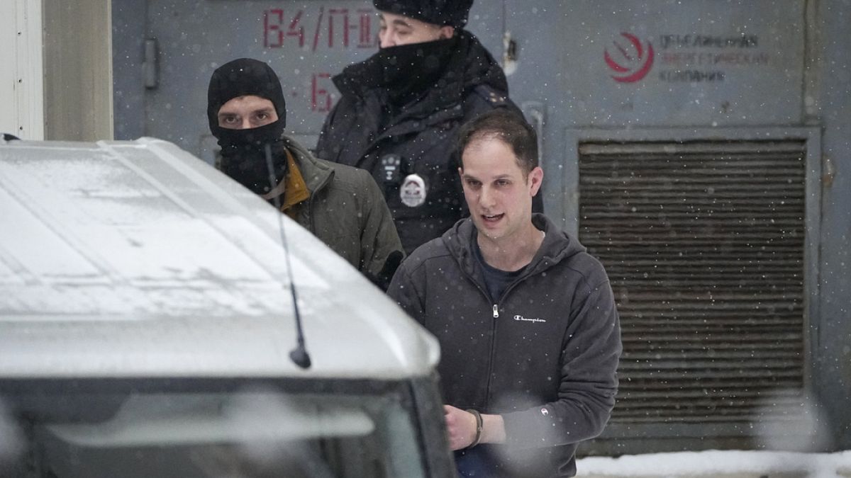 Wall Street Journal reporter Evan Gershkovich, right, is escorted from the Lefortovsky court in Moscow, Russia on Friday