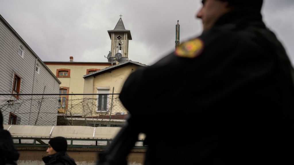 Turkish police officers stand guard in a cordoned off area outside the Santa Maria church, in Istanbul, Turkey, Sunday, Jan. 28, 2024.