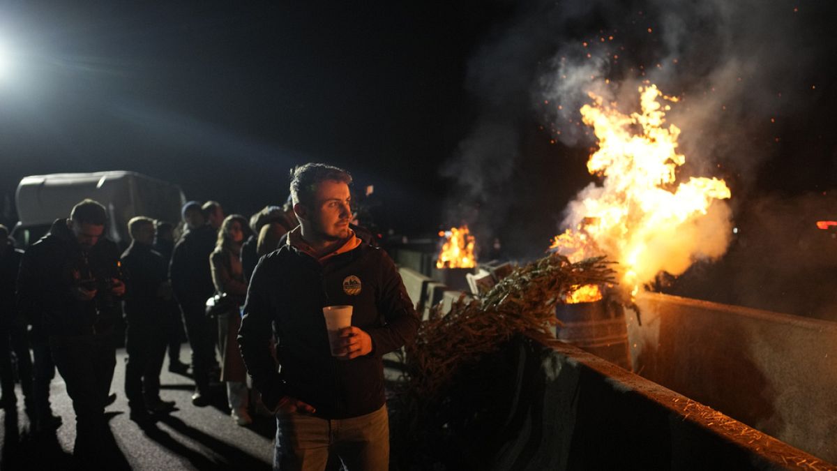 Protesting farmers encircled Paris with traffic-snarling barricades on Monday.