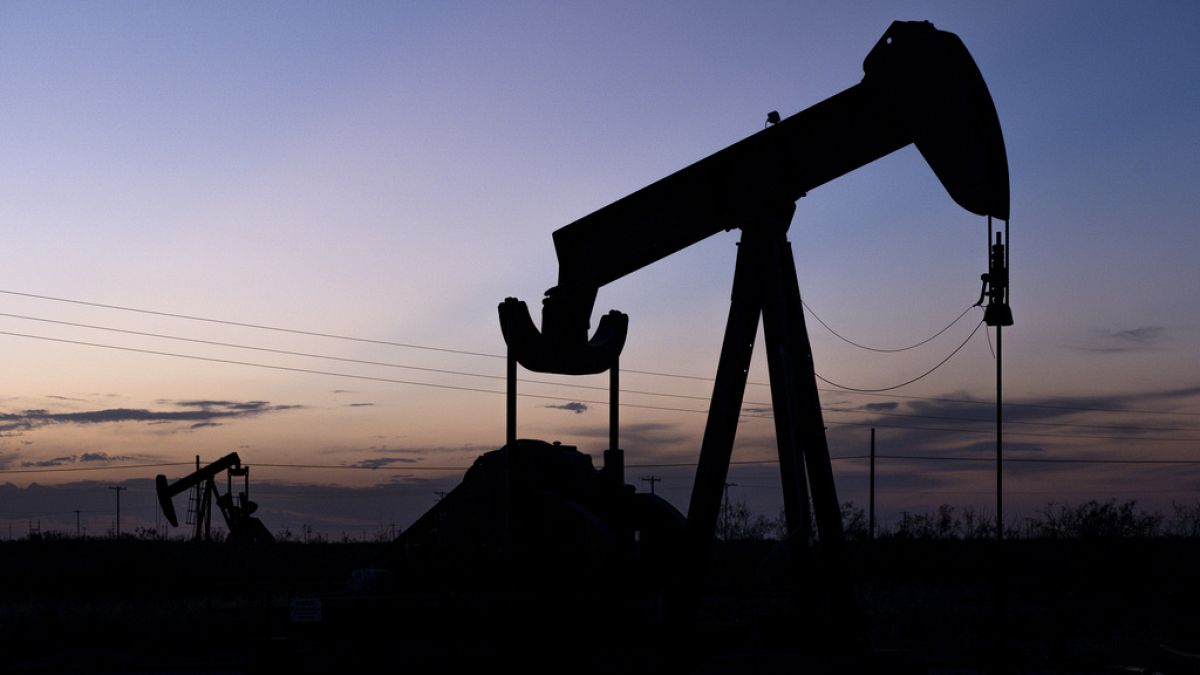 FILE -The sun sets behind a pair of pumpjacks Wednesday, Sept. 15, 2021 in the oilfields of Penwell, Texas. How science textbooks in Texas address climate change is at the cen