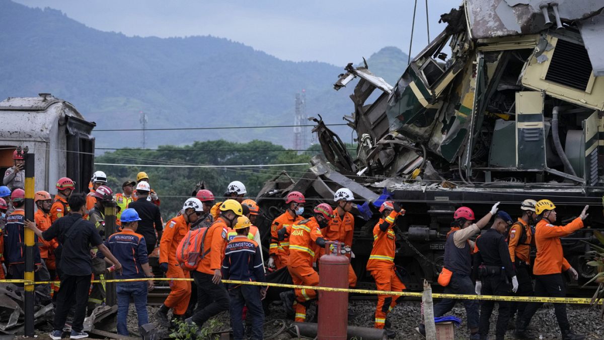 Rescuers remove the body of a train crash victim in Cicalengka, West Java, Indonesia, Friday, Jan. 5, 2024.