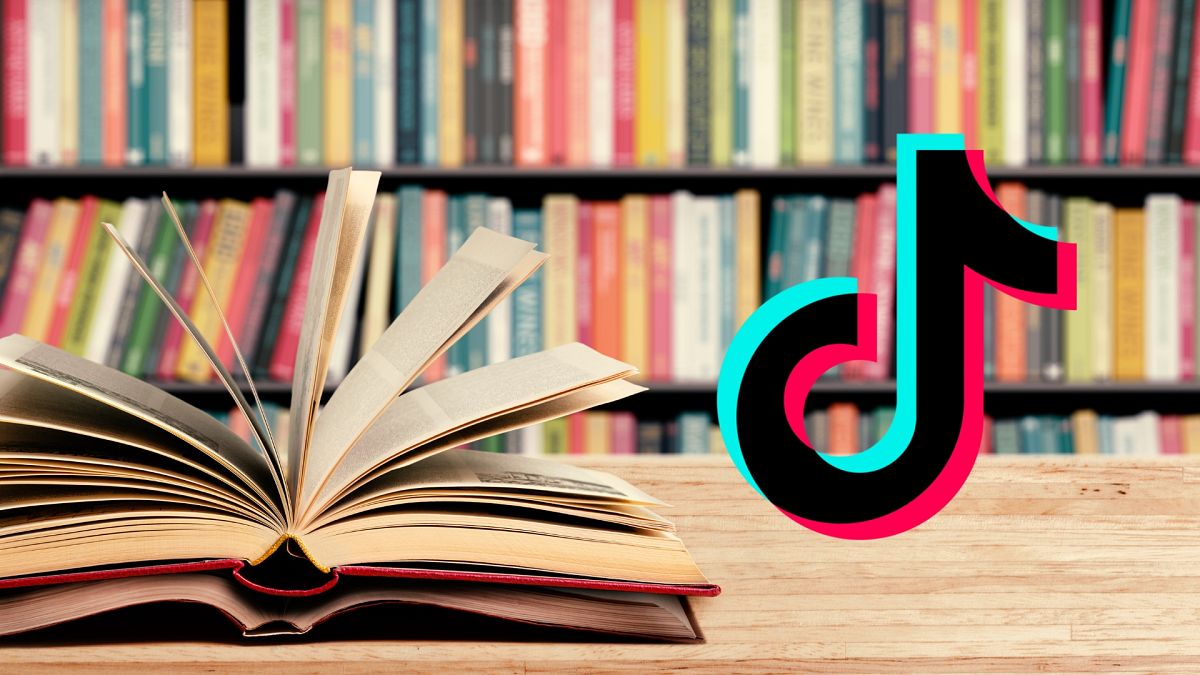 The TikTok logo next to a load of books`