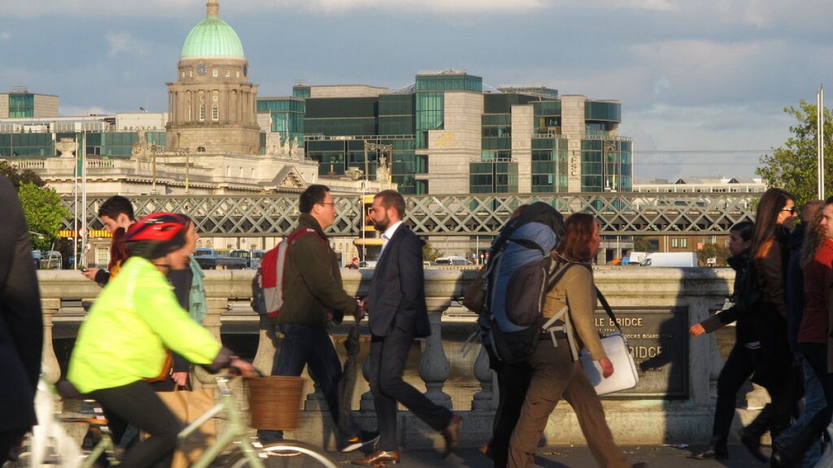 In this picture taken on Monday, Oct. 6, 2014, pedestrians and cyclists pass each other at evening rush hour on O