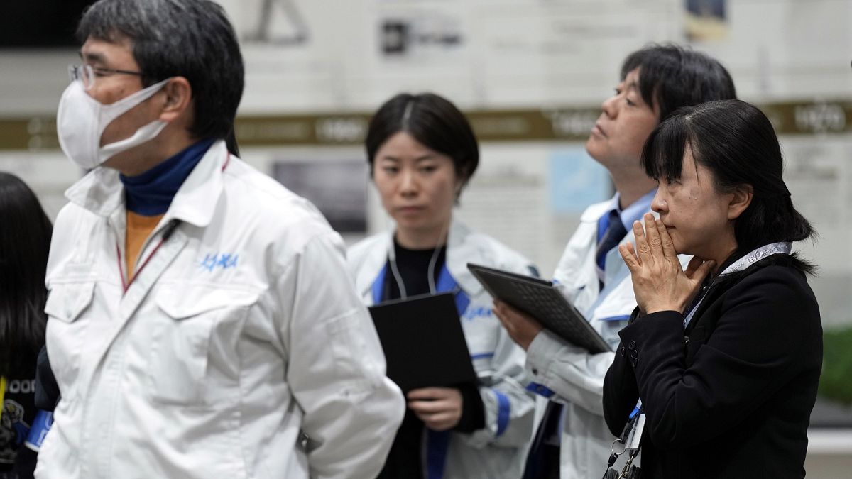 Staff of Japan Aerospace Exploration Agency (JAXA) watch a live streaming of the pinpoint moon landing operation by the Smart Lander for Investigating Moon (SLIM) spacecraft.