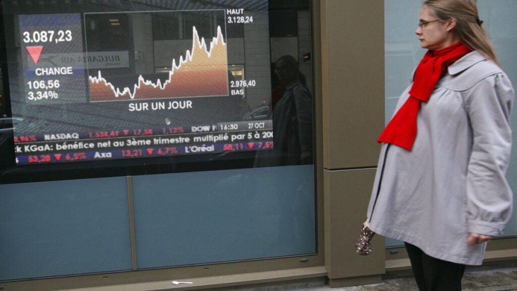 A woman looks at a television screen displaying the French CAC 40 stock market index, Monday, Oct. 27, 2008 in Paris. U.S. and European stock markets recovered much of their e