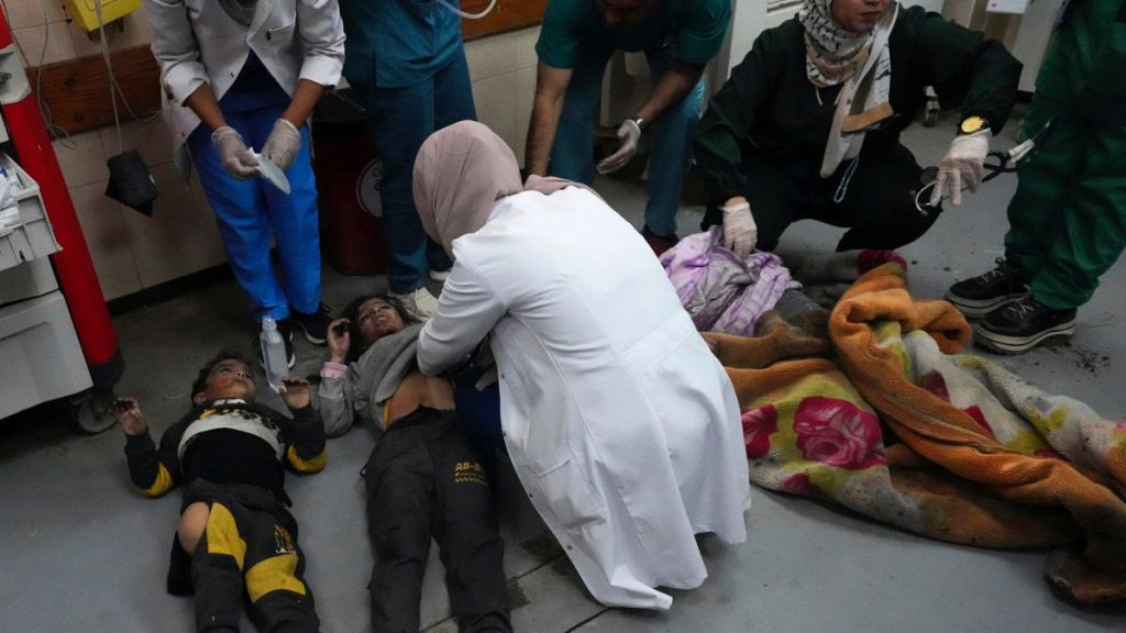 Palestinians wounded in the Israeli air and ground offensive on the Gaza Strip are brought to a hospital in Deir al Balah on Friday, Jan. 26, 2024.