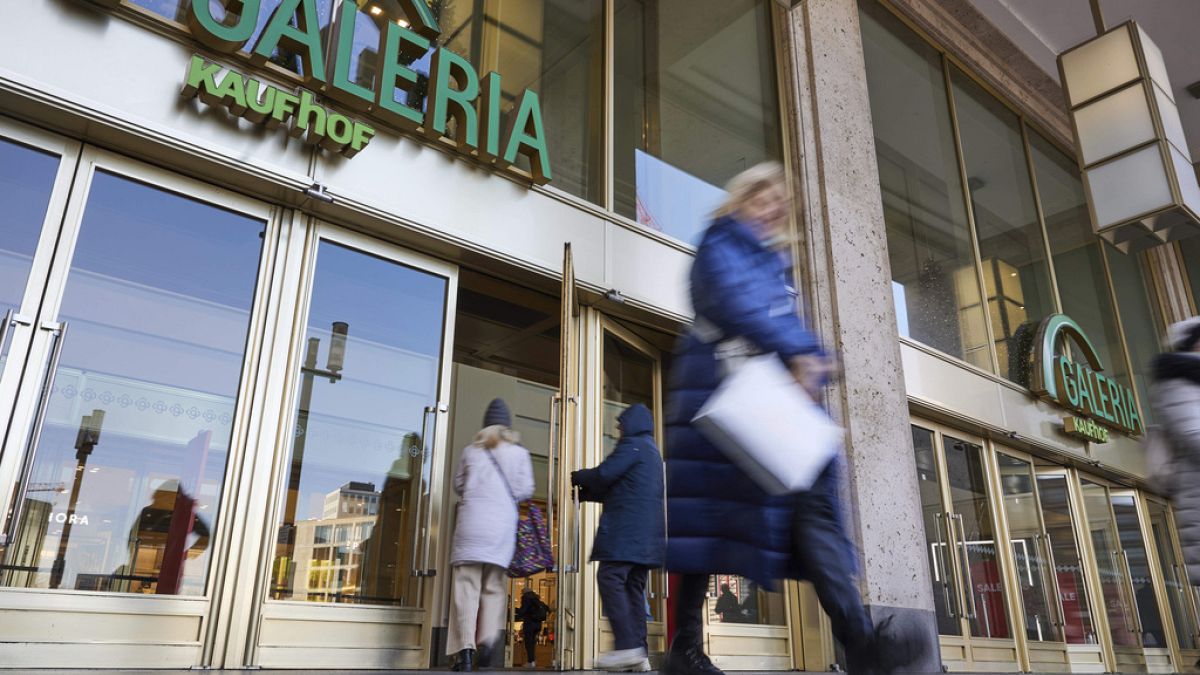 People enter and leave a branch of the department store Galeria Karstadt Kaufhof in Berlin, Germany, Tuesday, Jan. 9, 2024.