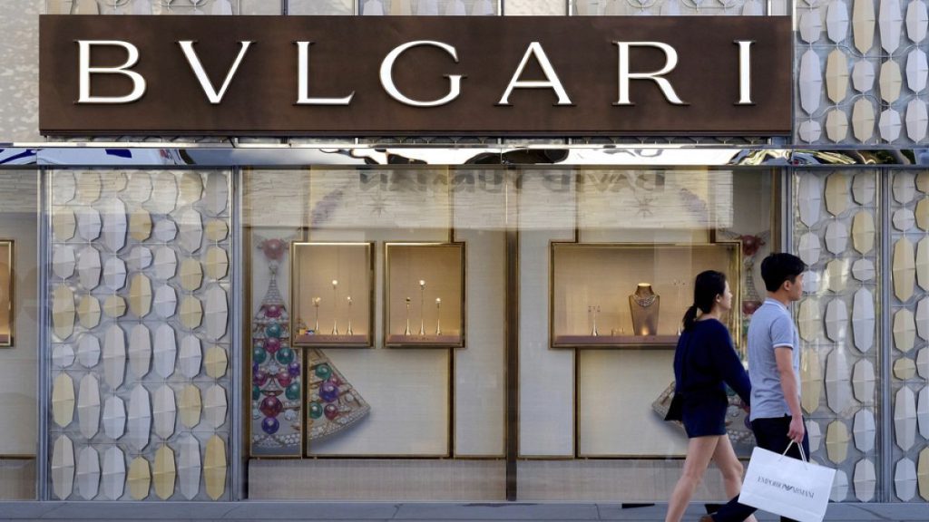 Shoppers walk past the Italian jewelry and luxury goods store, Bulgari in Beverly Hills, Calif, Thursday April 2, 2015.