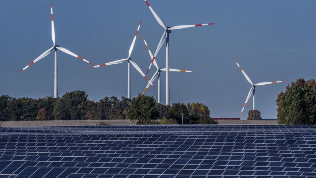 Wind turbines behind a solar farm in Rapshagen, 2021. The EU aims to cover at least 42.5% of its energy needs from renewable sources by the end of the decade.