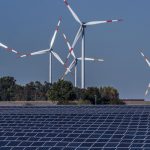 Wind turbines behind a solar farm in Rapshagen, 2021. The EU aims to cover at least 42.5% of its energy needs from renewable sources by the end of the decade.