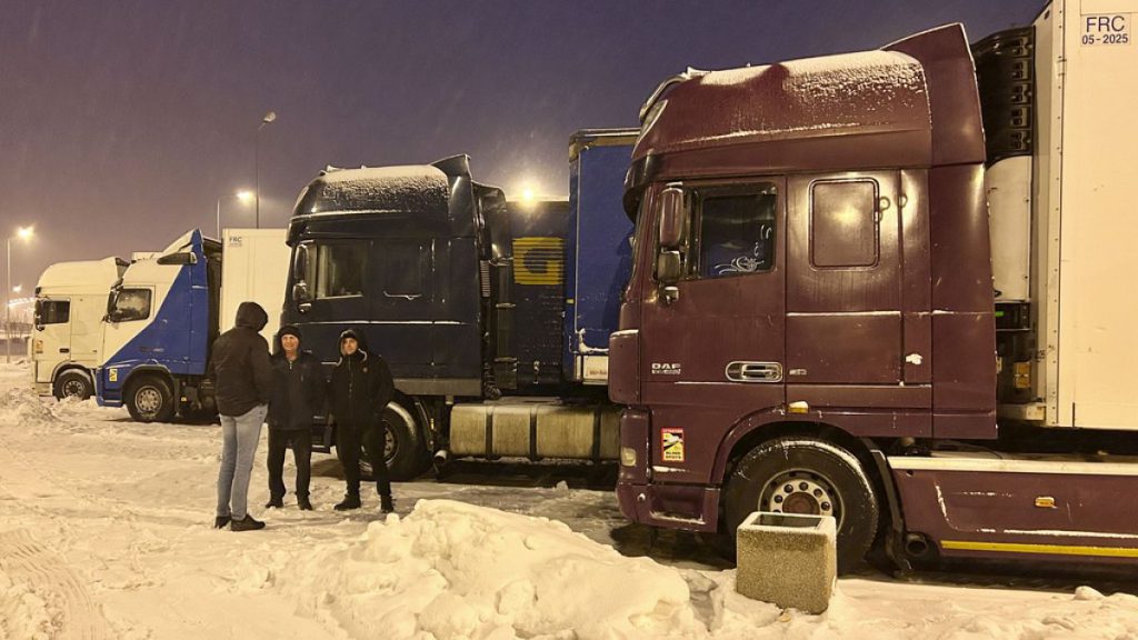 Ukrainian truck drivers wait to cross from Poland back into Ukraine in Korczowa, Poland in December