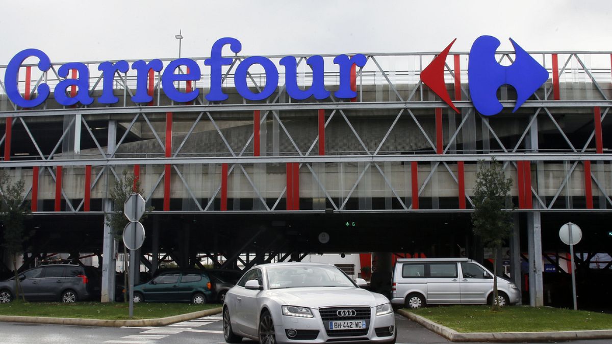 A car leaves a Carrefour supermarket in Anglet, southwestern France