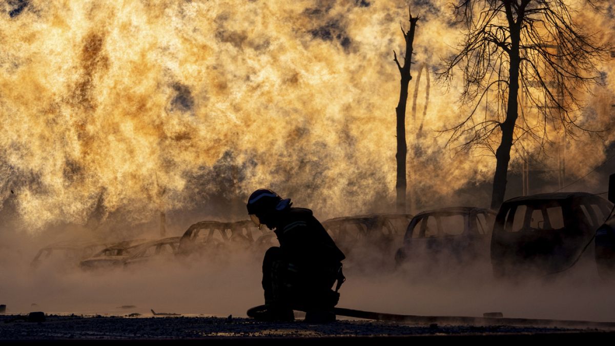 A firefighter works to extinguish a fire of a gas pipe line damaged by a Russian rocket attack, in Kyiv, Ukraine, Tuesday, Jan. 2, 2024.