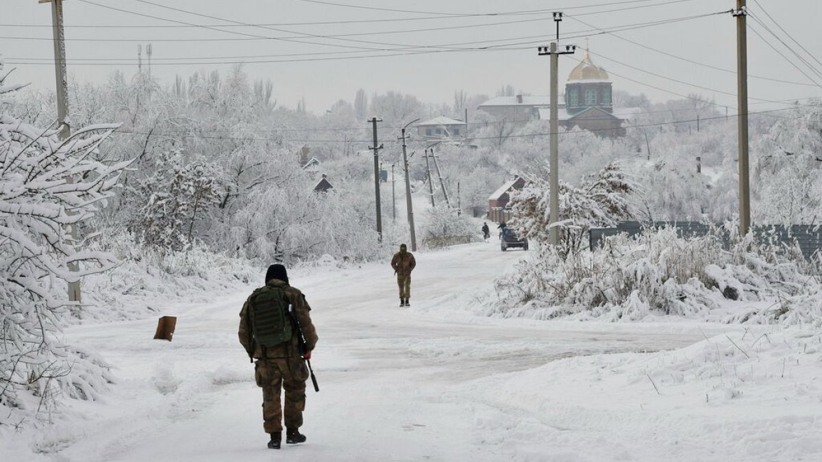 FILE - Ukrainian servicement partrol Verkhnotoretske village in Donetsk region, eastern Ukraine, Monday, Dec. 27, 2021.